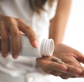 Woman taking fertility supplements from a bottle