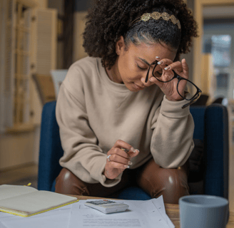 Woman calculating fertility treatment costs at home
