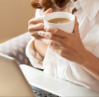 Woman drinking tea while researching fertility online