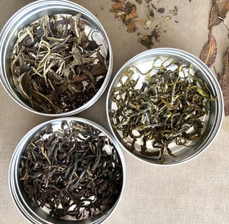 three tin cans of tea and some sort of tea