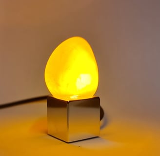 a yellow light bulb sitting on top of a table