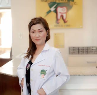 a woman in a lab coat standing in front of a counter