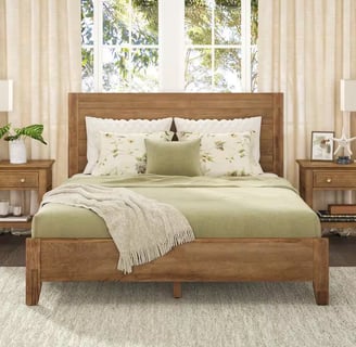 neutral bed frame with a green comforter with neutral side tables and cream linen curtains