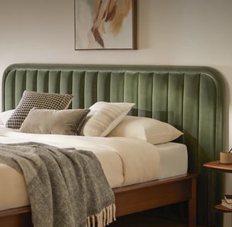 green bed frame with cream comforter and brown bedside table neutral painting and neutral paint