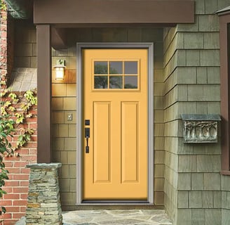 mustard  yellow front door with a green house 