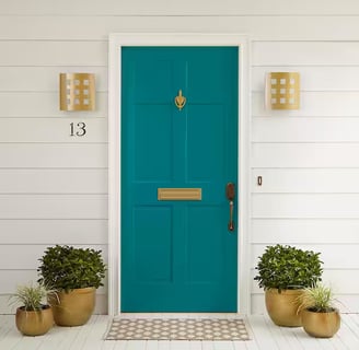 teal front door with gold hardware 