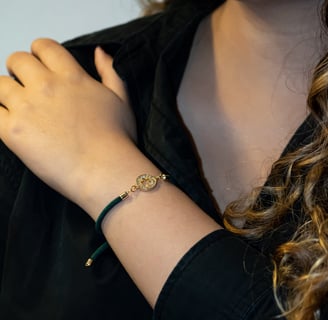 a woman wearing a black shirt and a gold bracelet