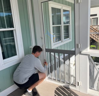 Technician rescreening a door with fiberglass screen. 