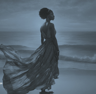 a woman in a dress standing on a beach