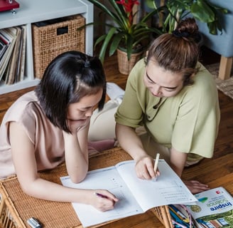 A mother and daughter study together.