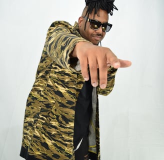 a man in a tiger print jacket pointing at the camera