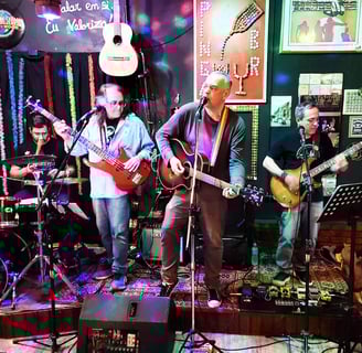 a band playing guitar in a bar
