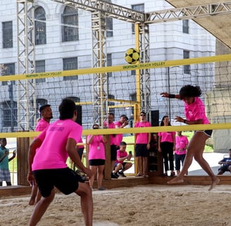 a group of people playing volleyball in a stadium