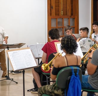 a man in a white shirt and a bandleader playing a trumpet