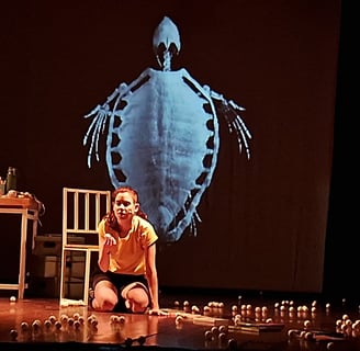 a woman sitting on a stage with candles and candles