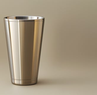 A polished stainless steel tumbler set on a minimalist surface, highlighting its sleek design.