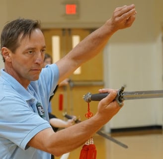 Johnny practicing the Combined 42 Tai Chi Sword form at the Tai Chi for Health annual workshop.