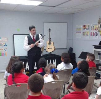Maestro Bobby Ramirez teaching kids about the flute