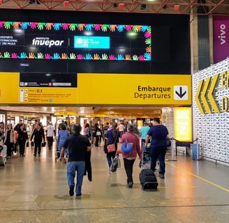 a group of people walking through a busy airport