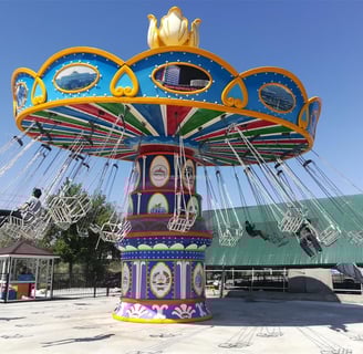 a colorfully decorated Flying Chair rides at a carnival
