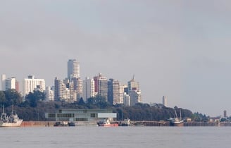 a city skyline with a large building in the background