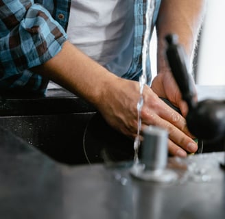 a man is washing his hands in a sink