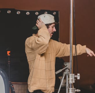 Man directing a lighting setup for a podcast in Dallas, Texas.