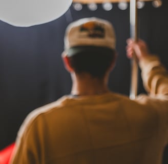 Man setting up a c-stand with a light in a podcast studio in Dallas, Texas.