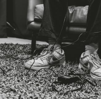 Audio cords wrapped around shoes in a podcast studio in Dallas, Texas.