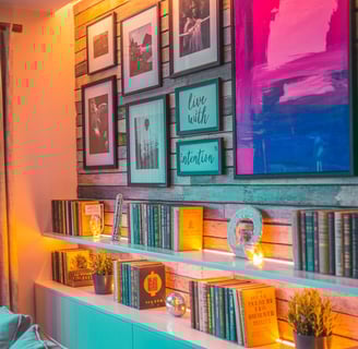 Feature wall with gallery art, bold colors, books, and LED lighting