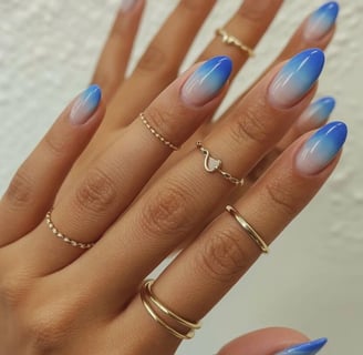 Almond nails with nude to blue ombre gradient