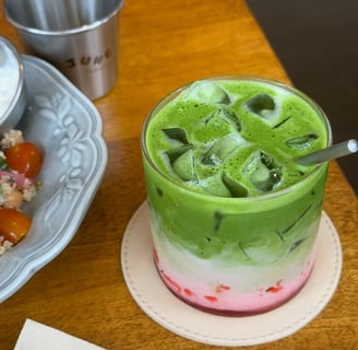 Layered strawberry matcha latte with fresh strawberries