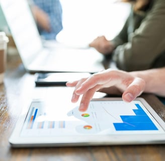 Profissionais de marketing jurídico mexendo em um tablet e notebook