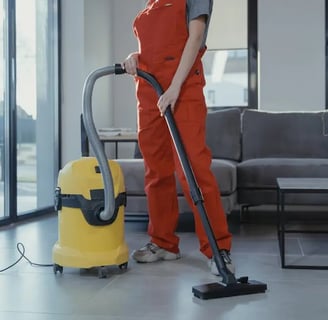a woman in overalls and overalls cleaning a house