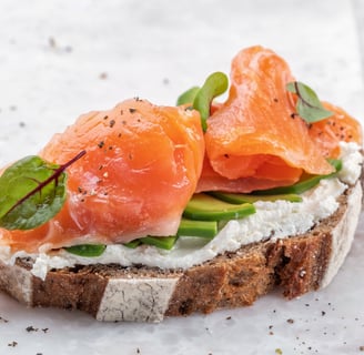 high protein whole grain toast topped with avocado cottage cheese and salmon slices