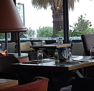 a table with a fire in the middle of a restaurant