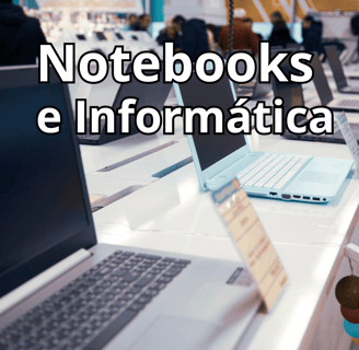 a laptop computer with a notepad and a notebook on a table