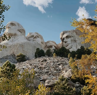 a mountain top with a view of mount rushmore in the background