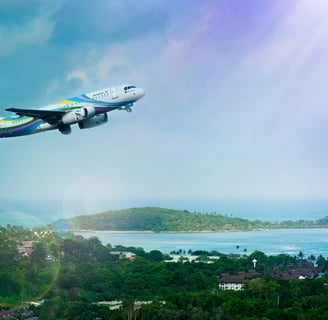 a plane flying over a lush green hillside