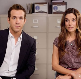 Andrew e Margaret interpretados por Ryan Reynolds e Sandra Bullock em A Proposta