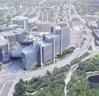 a large multi building office tower set in a city with a river running through it