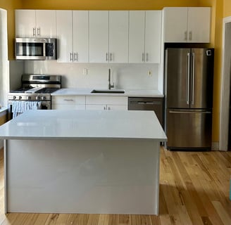 a kitchen with a stainless steel refrigerator and a refrigerator
