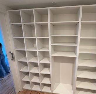 a closet with a closet door open and a person standing in front of it