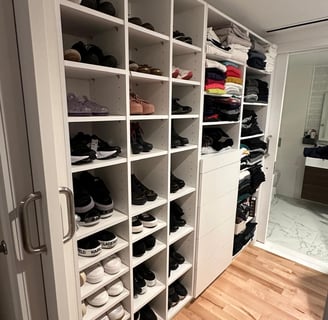 a closet with a lot of shoes and a door