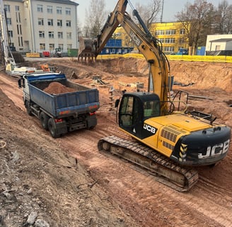 ekskavatorius krauna gruntą į sunkvežimį