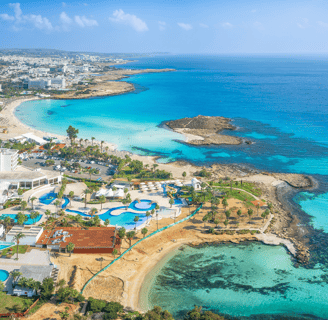 a large body of water with a beach and a resort