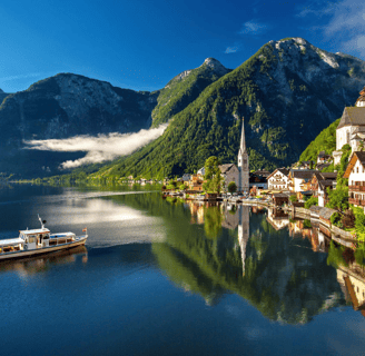 a boat is coming down the river in a beautiful mountain setting