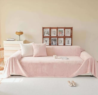 Cozy living: Soft pink reading sofa, matching pillows, and a peaceful nook by a large window.