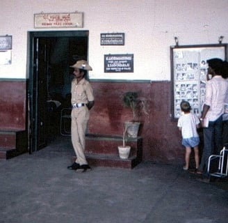 A police man standing in front of Police Station