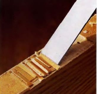 a knife sharpe knife cutting a piece of wood